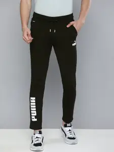 Puma Puma Men Black Typography printed Mid Rise Elasticated Dry Cell Tapered Track Pants