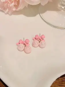 VAGHBHATT Gold-Plated Pearls Studded Bow Shaped Studs