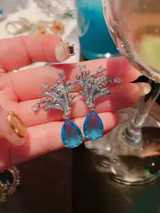 Jewels Galaxy Silver Plated American Diamond Studded Teardrop Shaped Drop Earrings