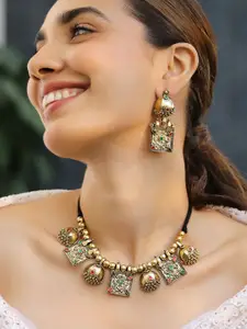Rubans Oxidised Antique Gold-Plated Tribal Necklace Set with Dome Accent & Red-Green Stone