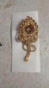 Ornate Gold-Toned Saree Pin with Gemstones and Dangling Pendant