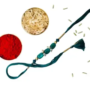 Bold and beautiful intricate beaded handcrafted rakhi (NeelSutra) in a new teal color with gold zari and pearl accent with traditional kumkum chawal set.